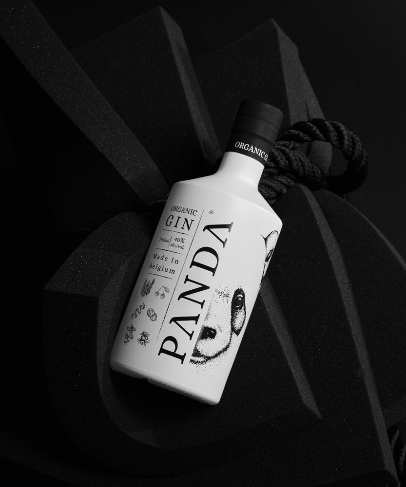 A bottle of original, organic, lychee-infused Panda Gin on a black background