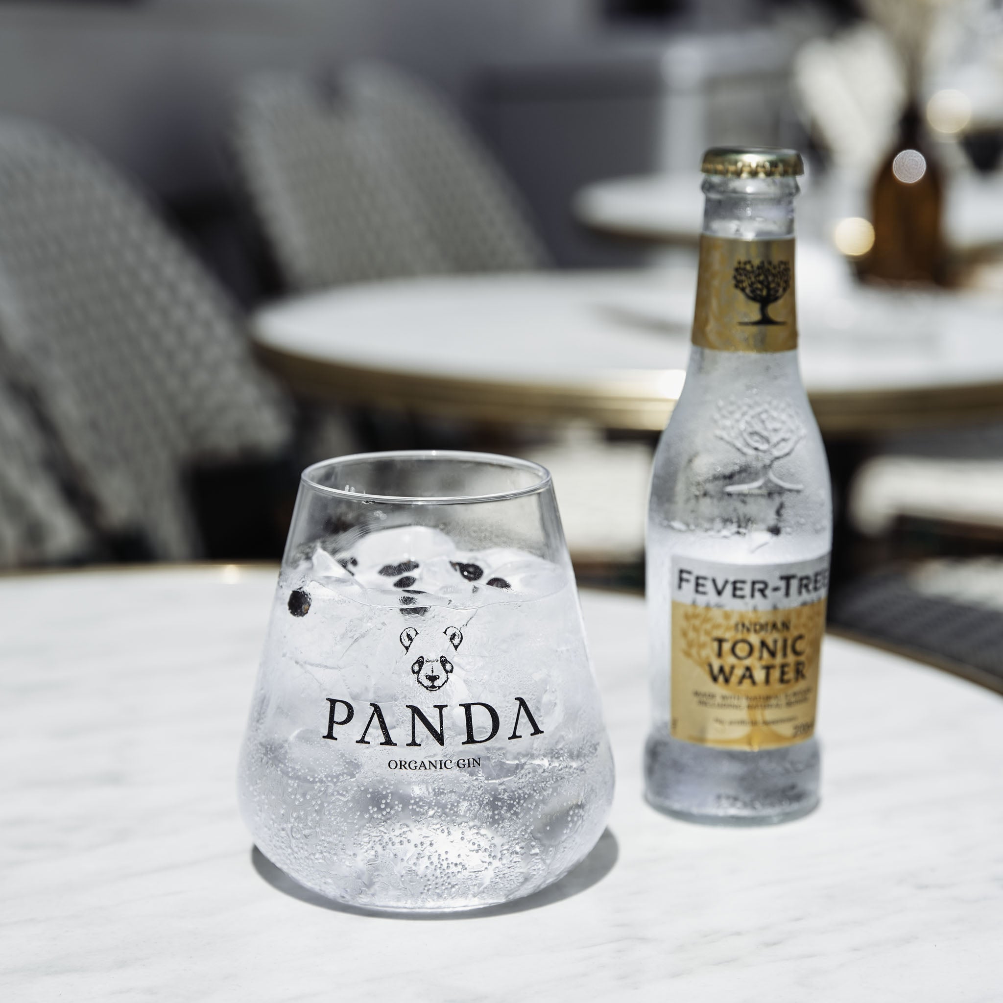 The perfect service, a glass with ice cubes, Panda Gin and premium Tonic